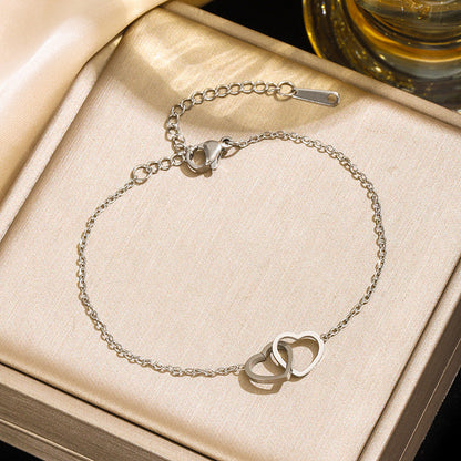 Two Hearts Bracelet in gold and silver, both color options shown together