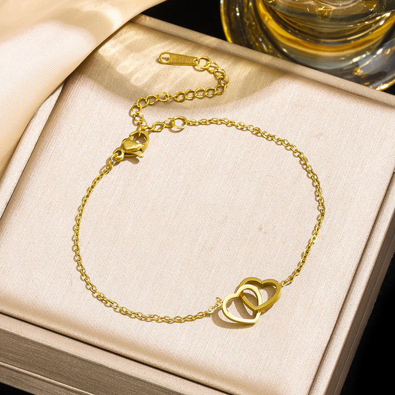Close-up of interlocking heart charm on Two Hearts Bracelet chain